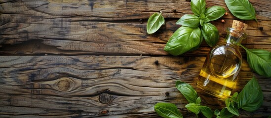 Poster - Aroma oil of basil and fresh leaves on a textured wooden backdrop illustrating the use of medical herbs in aromatherapy alternative medicine with available space for text in the image