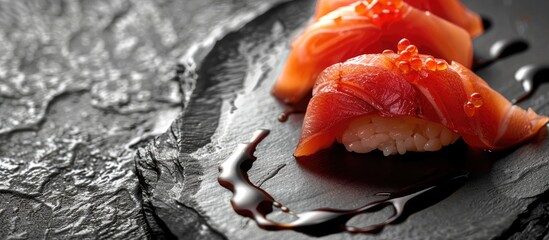 High resolution high quality photo of a close up sashimi sushi plate on a black surface with soy sauce including a stunning image with ample copy space