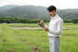 © wichayada - Agricultural Researcher Using Tablet Technology in Field for Modern Farming and Data Analysis