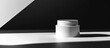 © Ilgun - Close up of a white glass container for cosmetic cream on a white background with a black shadow perfect for a copy space image