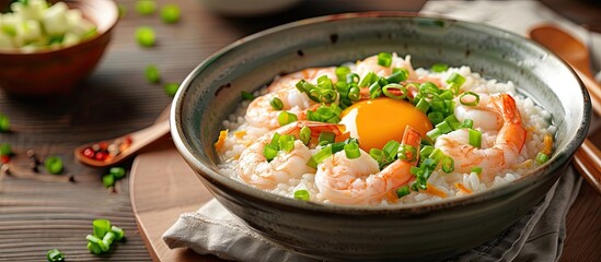 Sticker - Delicious shrimp porridge topped with eggs and fresh spring onions served in a bowl with a generous helping a mouthwatering dish with copy space image