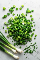 Wall Mural - A bunch of green onions are spread out on a white background. The onions are cut in half and scattered around the image