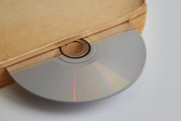 Aufkleber - An old book and a CD between the pages inside, a CD as a bookmark in a book, a digital library, archival records