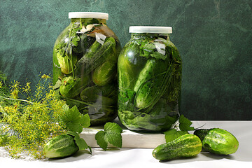 Wall Mural - Pickled cucumbers in a jar with garlic and dill on the kitchen table, village harvest, homemade pickling recipe, cucumbers and ingredients for pickling, home canning concept, healthy and natural food.