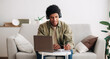 © Prostock-studio - Web-based education concept. Positive teen student in headphones writing in notebook during online lecture on laptop. Cool African American guy doing homework and listening to webinar, panorama