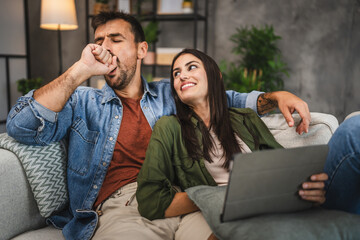 Wall Mural - Girlfriend watch movie on tablet with her sleepy boyfriend