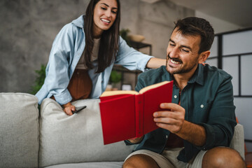 Wall Mural - Boyfriend show and explain interesting part of book to his girlfriend