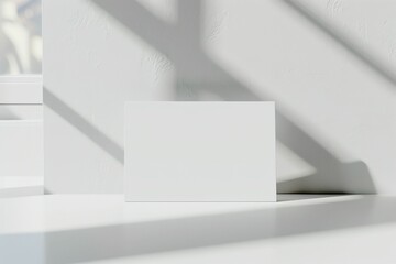 Leinwandbilder - A white rectangular canvas is placed against a sunlit neutral background, casting elegant shadows that enhance the minimalist and modern style of this artistic setup.