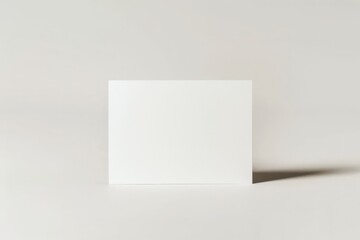Leinwandbilder - A single plain white card centered on a light gray background, symbolizing minimalism and open possibilities for design with its clean and uncluttered appearance.