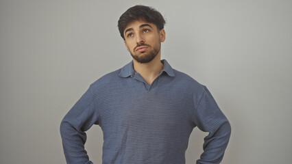 Handsome young man with beard posing confidently isolated against white background