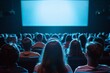 © nsit0108 - Large group of people watching a blank movie screen in a dark theater