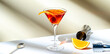 © 5ph - Orange cocktail with red vermouth, liqueur, bitter, citrus zest and ice in martini glass on beige background, hard light, banner