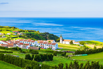 Wall Mural - View of small town with typical houses and church on north eastern coast, Sao Miguel island, Azores, Portugal