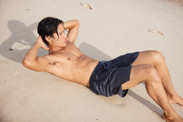 Wall Mural - Active Asian Athlete: Enjoying the Sunset Run on the Beach, Fitness and Freedom