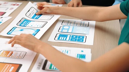 Panorama video of startup UX developer or company employee design user interface or UI prototype for mobile application or website software with software display on smartphone in office. Synergic