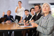 © JackF - Interested aged businesswoman sitting at table in office, listening attentively to presentation of partners during meeting