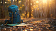 © 沈军 贡 - A backpack and map lying on the ground in an forest at sunrise