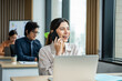 © Kawee - Asian happy businesswoman talking on smartphone and working in office.