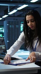 Poster - vertical video engineer in data center installing software on computer, helping maintain network, tr