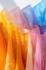 Wall Mural - A set of colorful napkins with a blue napkin on the left, a pink napkin in the middle, and an orange napkin on the right