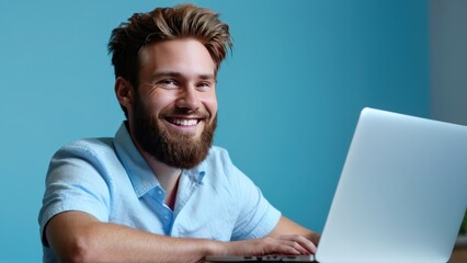 Wall Mural -  a bearded man has his laptop pulled open,