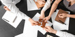 © Pixel-Shot - Team of business people doing puzzle in office