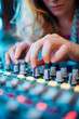 © ALLAI - Close-up of female producer's hands on sound mixing board
