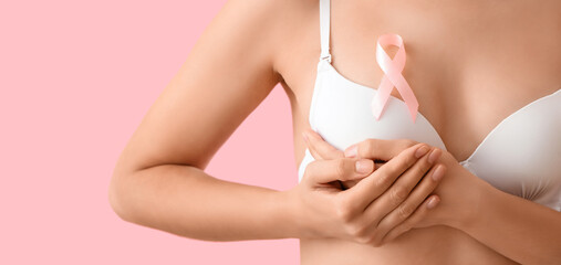 Sticker - Woman in underwear with pink ribbon on color background, closeup. Breast cancer awareness concept