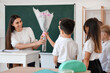 © Pixel-Shot - Little school children greeting teacher in classroom