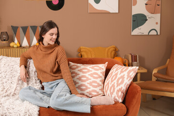 Sticker - Happy young woman sitting at home on autumn day