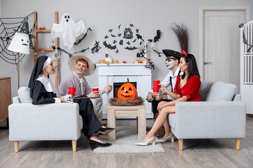 Canvas Print - Group of friends in costumes drinking at Halloween party