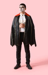 Poster - Young man dressed for Halloween as vampire on pink background