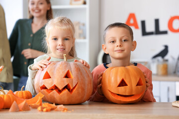 Poster - Little children with carved Halloween pumpkins in kitchen