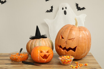 Wall Mural - Carved Halloween pumpkins on wooden table