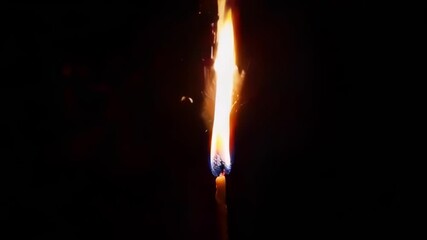 Wall Mural - a close up of a flame igniting with vibrant sparks, suggesting celebration and energy in a dark sett
