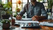 © Dikejar - Man Working on Financial Documents at a Desk