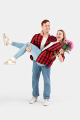 Canvas Print - Happy young couple with chrysanthemum flowers on white background