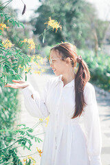 Wall Mural - cute girl outdoor with yellow flower