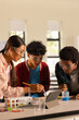 © wavebreak3 - Conducting science experiment, teenagers using tablet and lab equipment in high school