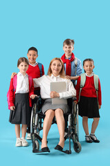 Wall Mural - Mature teacher in wheelchair with laptop and little pupils on blue background