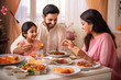 © PRASANNAPIX - happy indian family eating dinner at home