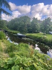 Poster - Picturesque view of river, trees and moored boats