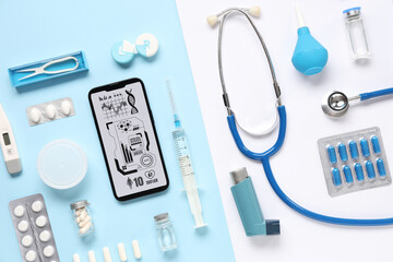 Wall Mural - Mobile phone with medical supplies on blue and white background. Telemedicine concept