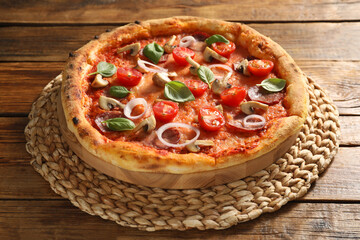 Wall Mural - Delicious pizza with salami, tomatoes, mushrooms and basil on wooden table, closeup