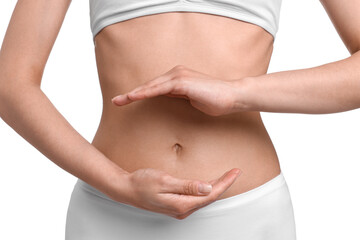 Wall Mural - Healthy digestion. Woman holding something near her belly on white background, closeup