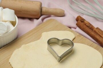 Wall Mural - Raw dough, cookie cutter and rolling pin on table, closeup