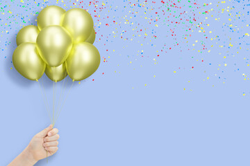 Aufkleber - Female hand holding bunch of shiny golden or yellow balloons on blue background with confetti. Empty space for text