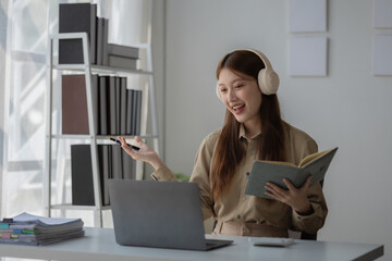 Wall Mural - an Asian beautiful businesswoman and her team are discussion via video conference with her client about planing of new strategy, a CEO is meeting with her team via video call in her private office,