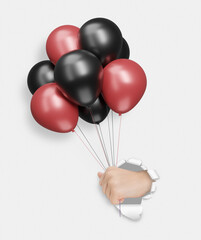 Aufkleber - Female hand holding red and black shiny balloons through the hole in white paper