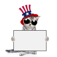 Poster - Cute kitten wearing like Uncle Sam looks at camera and shows blank whie board. isolated on white background